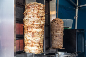 Kebab meat cooking on a skewer in a cafe fast food seller