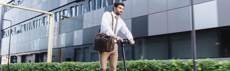 bearded businessman in formal wear riding electric scooter, banner