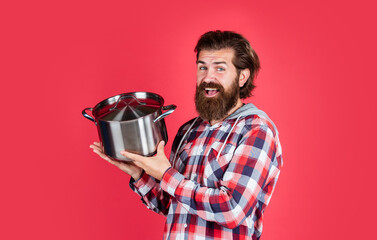 Cooking healthy. Nonstick pan coated polytetrafluoroethylene teflon. Cooking healthy food. Professional chef man cook in shirt. bearded husband. Restaurant. Enameled cast iron cooking vessels