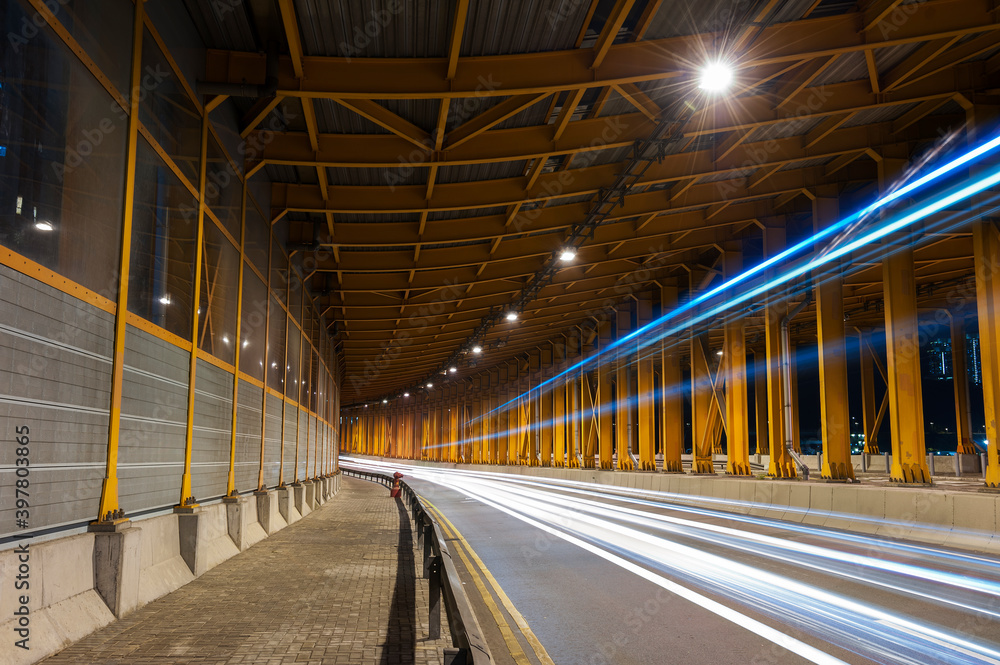 Poster light trails and head lights of traffic in tunnel. transportation background