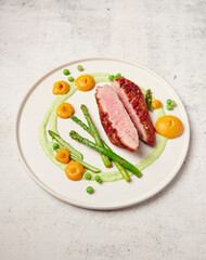 Duck breast with asparagus and pumpkin puree