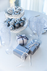 
Blue gift box on a beige background with place for text.