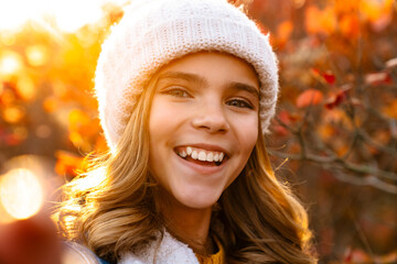 Close up portrait of a young girl in warm hat