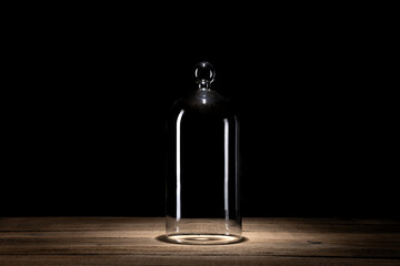 Empty glass dome on old wooden table. Close up on dark background. Copy space. © raland