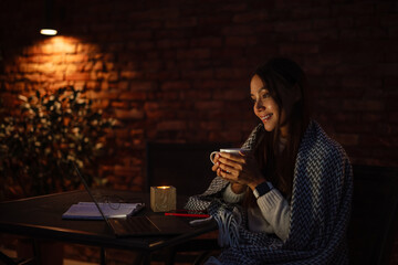 Attractive young asian woman covered in blanket