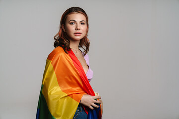 Caucasian beautiful young woman posing with rainbow flag