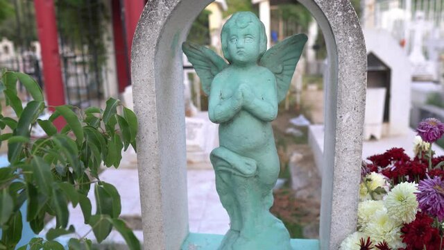 Statue of a little angel on cementery