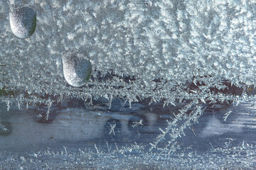 Beautiful natural background or texture of frozen transparent glass on the window in winter, strong...