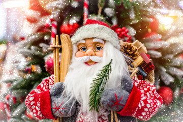 Santa Claus with gifts on the background of the Christmas tree
