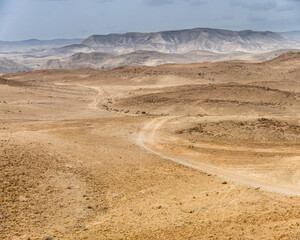 The road goes along the plateau to the edge of the canyon. Panorama from several shots.