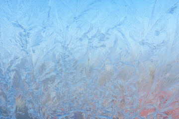 Winter background on a transparent glass of a window with a frozen texture. Abstract texture background, horizontal image, copy space for your design or text