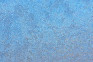 Winter background on a transparent glass of a window with a frozen texture. Abstract texture background, horizontal image, copy space for your design or text