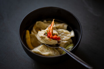 Korean Squid Dumpling Soup which is called MandutGuk with Kimchi