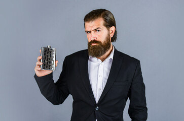 best taste. man drinks strong alcohol from iron flask while relaxing. Hip flask for whiskey....