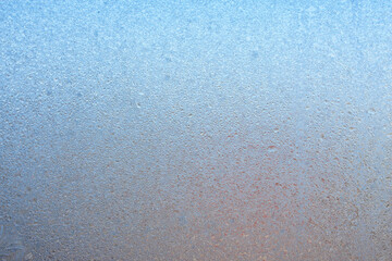 Completely frozen window on transparent glass. Clean background. Extreme low temperatures in winter. Water vapor condenses on cold window glass and freezes