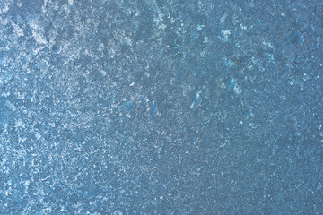 Completely frozen window on transparent glass. Clean background. Extreme low temperatures in winter. Water vapor condenses on cold window glass and freezes