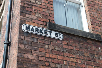 Market Street road sign on an old brick wall of a house.