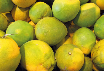 Tasty and sweet navel oranges background. Close up of ecological and organic citrus. Fruits pattern. Top-down view of Big pile of fresh and healthy oranges.