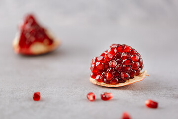 Piece of fresh pomegranate fruit on neutral background