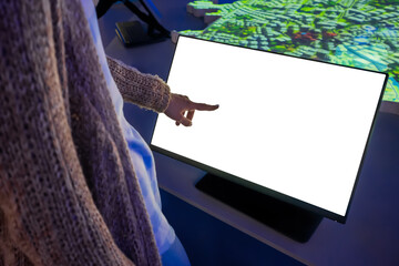 Woman hand using white blank interactive touchscreen display of electronic multimedia kiosk in dark...