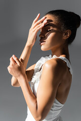 Fototapeta premium graceful african american ballerina in sunlight on white background