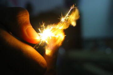 hand holding a burning match