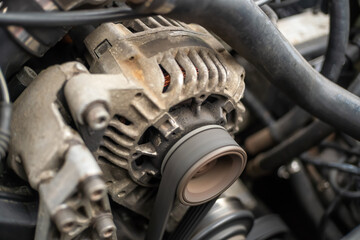 AC generator for a car close-up, the engine compartment of a passenger car.