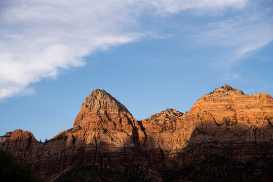 massive red rocks towering above zion national park © Zach