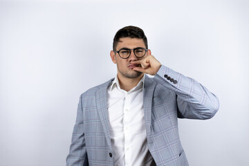 Business young man wearing a casual shirt over white background mouth and lips shut as zip with...