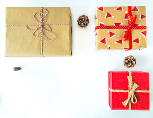 Christmas present boxes with pine cones on an isolated white surface with copy space