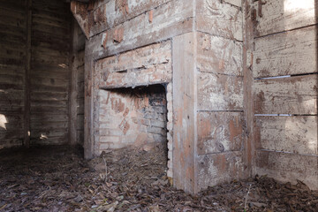 Fototapeta na wymiar Vintage red brick fireplace in an abandoned shanty in the deep south