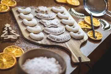 Homemade christmas cookies on wooden table. Sugared traditional vanilla crescent biscuits