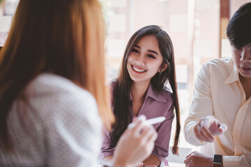 Diverse young businesswomen discussing,brainstorming together at workplace. Multi ethnic colleague...