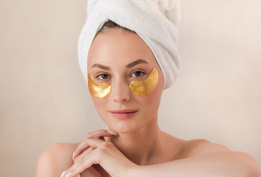 Beauty face woman natural healthy cosmetic skin pure suresh beautiful female happy smile portrait manicure hand. Beauty portrait of an attractive girl with a gold patch under the eyes.