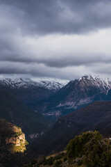 Snow capped summit behind the clouds