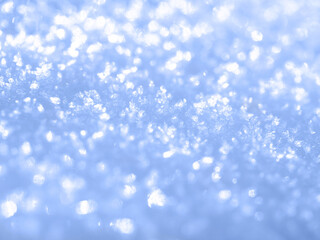 Blurry background of clear blue snow.