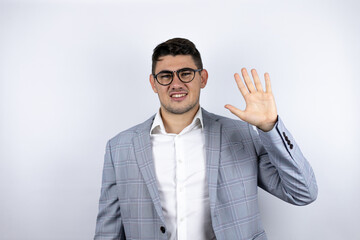 Business young man wearing a casual shirt over white background smiling confident and happy showing number five with fingers