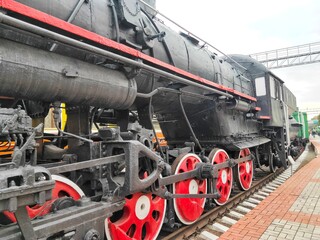 old steam locomotive of black and red color.
