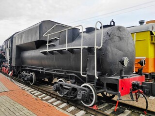 old steam locomotive of black and red color.