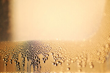 Sharp water drops on the misted window glass. Condensate in the winter. Copy space for advertisement text
