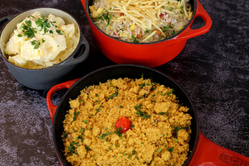 Brazilian farofa in a small red pot. Concept of a restaurant