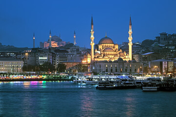 Fototapeta na wymiar Evening view of Yeni Mosque, Hagia Sophia, Eminonu pier and Galata Bridge in Istanbul, Turkey