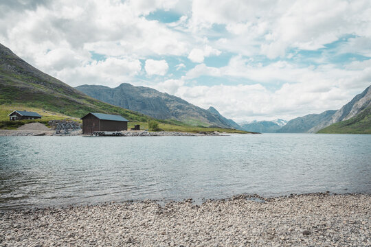 Wooden house in the mountains by the lake. House by the river in Norway