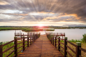 Sunset over a small pier in wetland area of the Isimangaliso National Park in KwaZulu-Natal region...