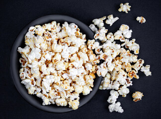 Homemade Kettle Corn Popcorn on black background with copy space. Top view.