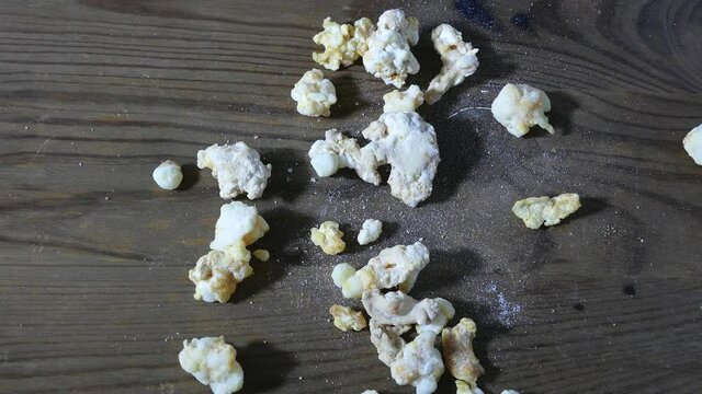 Hand throws down rocks of crack cocaine drug