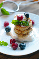 panquecas de queijo cottage na farinha de aveia com creme e frutas frescas.
