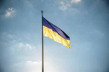 Ukrainian blue and yellow flag on the sky background