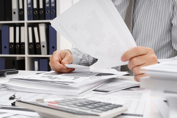 business problem concept - disappointed businessman has trouble and tears up reports