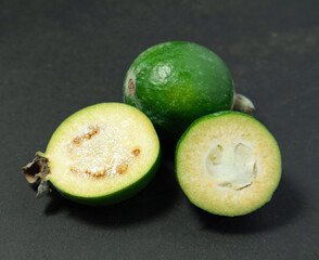 Feijoa fruits on black background. Tropical ripe feijoa fruits.